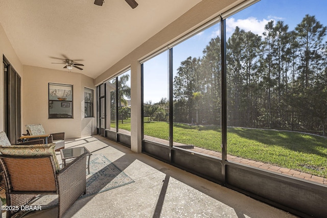 unfurnished sunroom with ceiling fan