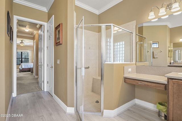 ensuite bathroom with a shower stall, ensuite bathroom, crown molding, and wood finished floors