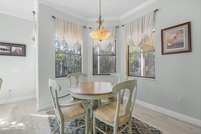 dining room featuring a healthy amount of sunlight, wood finished floors, and crown molding