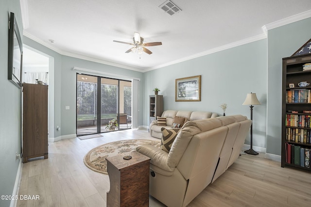 living area featuring light wood-type flooring, baseboards, visible vents, and crown molding