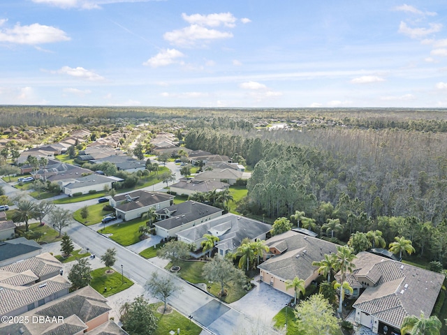 birds eye view of property featuring a forest view and a residential view