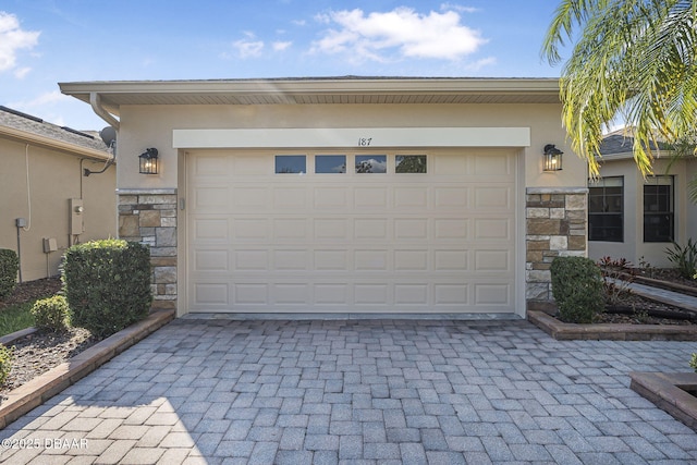 garage featuring decorative driveway