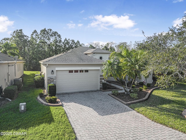 ranch-style home featuring an attached garage, stone siding, decorative driveway, stucco siding, and a front yard