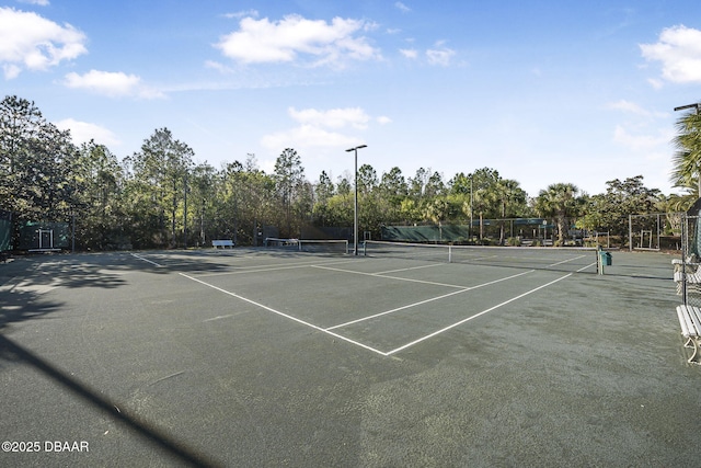 view of tennis court with fence