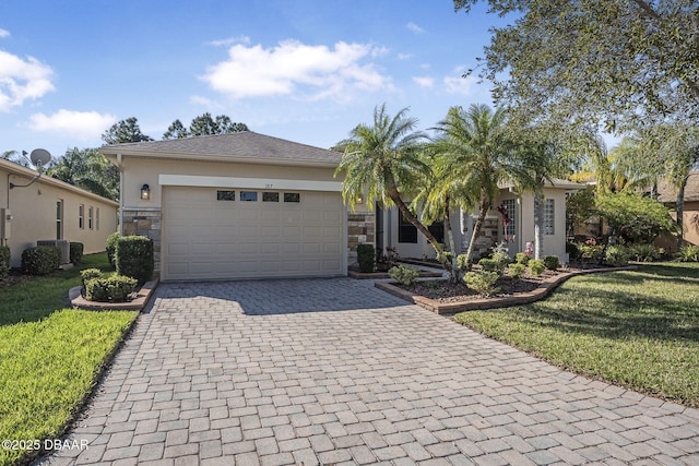 ranch-style home with a garage, stone siding, a front lawn, and decorative driveway