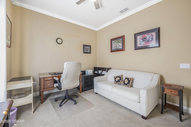 office space with carpet flooring, a ceiling fan, visible vents, baseboards, and ornamental molding