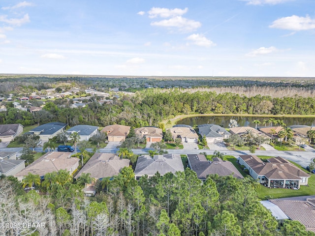 birds eye view of property with a water view, a residential view, and a wooded view