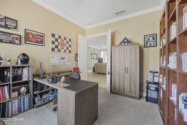 office space featuring carpet floors, visible vents, crown molding, and baseboards