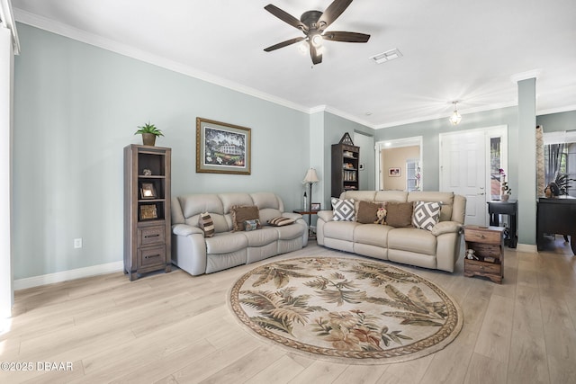 living room with baseboards, visible vents, a ceiling fan, crown molding, and light wood-style floors