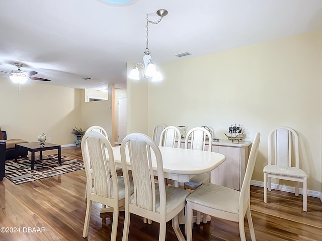 dining room featuring hardwood / wood-style floors and ceiling fan with notable chandelier