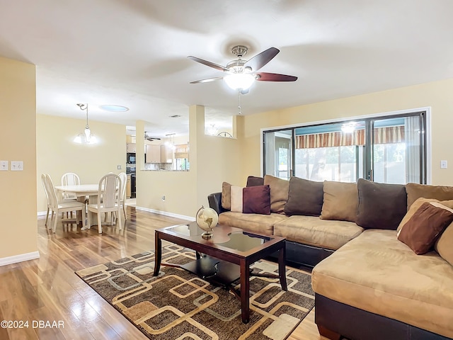 living room featuring ceiling fan and light hardwood / wood-style floors