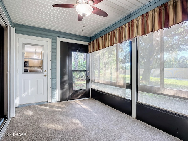 unfurnished sunroom featuring ceiling fan