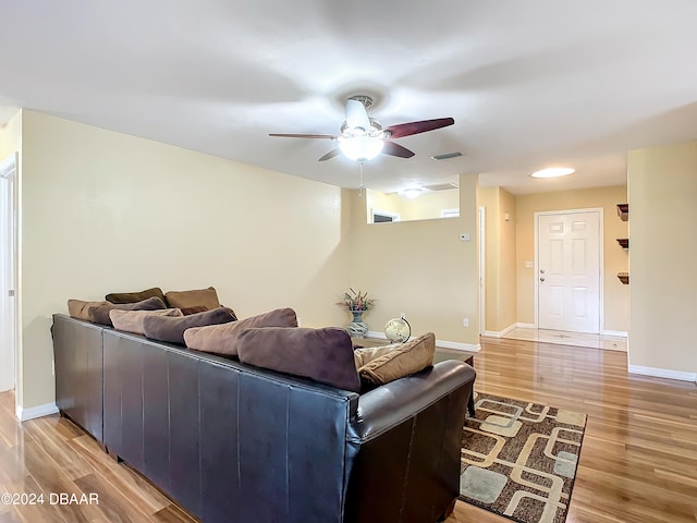 living room featuring hardwood / wood-style flooring and ceiling fan