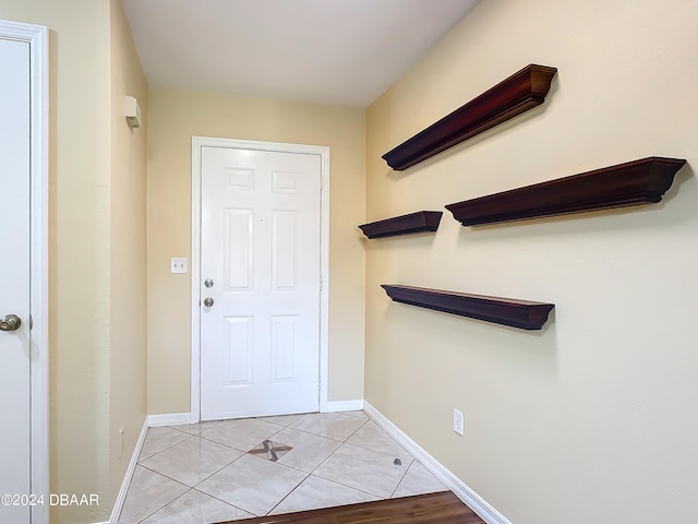 doorway with light tile patterned floors