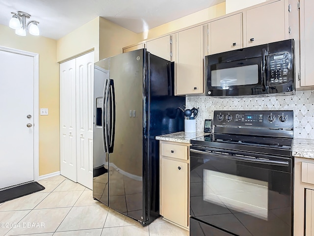 kitchen featuring decorative backsplash, black appliances, light tile patterned floors, a notable chandelier, and light stone countertops