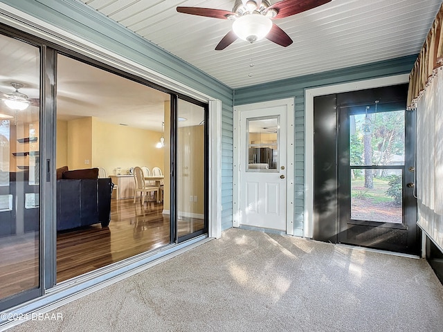 interior space with wooden ceiling and ceiling fan