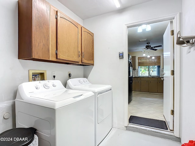 washroom featuring cabinets, ceiling fan, light tile patterned floors, and separate washer and dryer