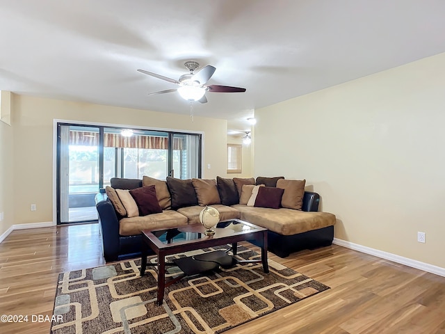 living room with light wood-type flooring and ceiling fan