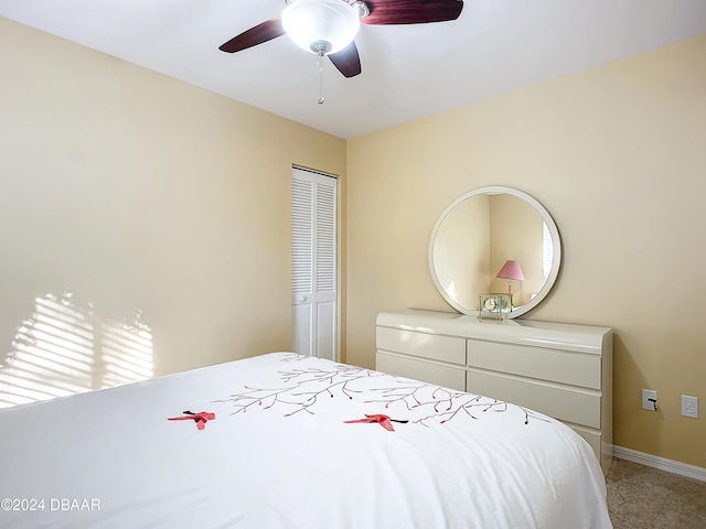 carpeted bedroom with a closet, multiple windows, and ceiling fan