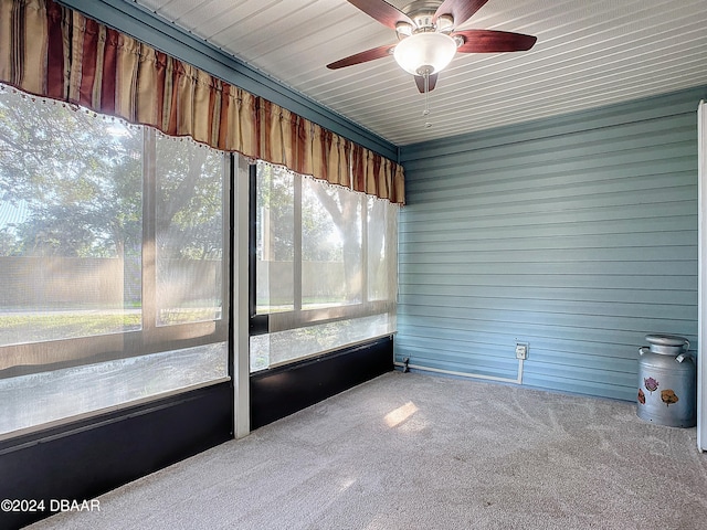 unfurnished sunroom with ceiling fan