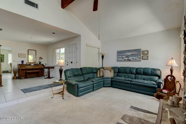 living room with visible vents, beam ceiling, light colored carpet, a ceiling fan, and light tile patterned floors