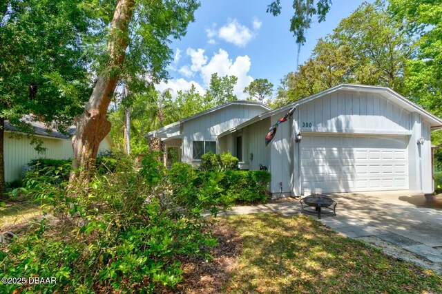 single story home featuring an attached garage and driveway