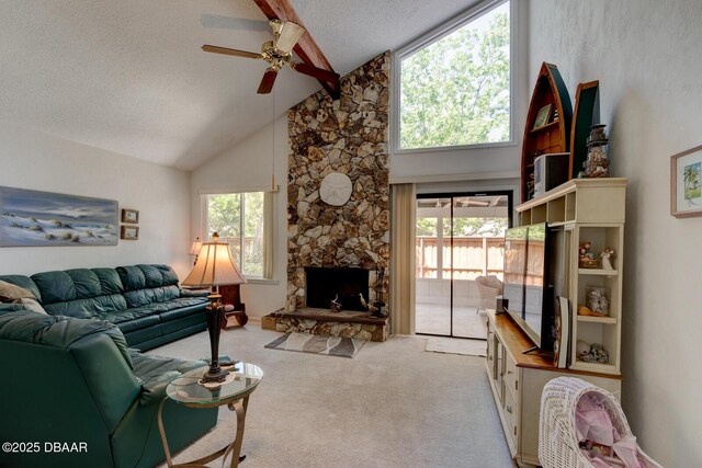 carpeted living room featuring a ceiling fan, a textured ceiling, a fireplace, high vaulted ceiling, and beamed ceiling