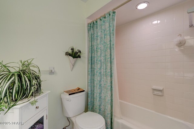 full bath with toilet and shower / bath combo with shower curtain