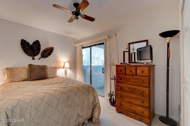 bedroom featuring a ceiling fan, a textured ceiling, light colored carpet, and access to exterior