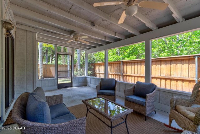 sunroom featuring an outdoor living space, ceiling fan, and beamed ceiling