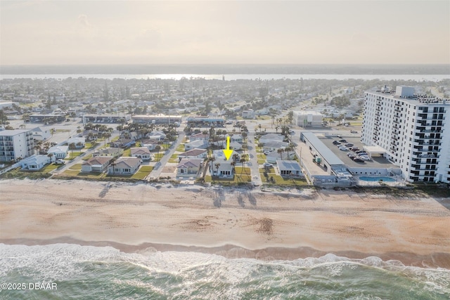 drone / aerial view featuring a view of the beach and a water view