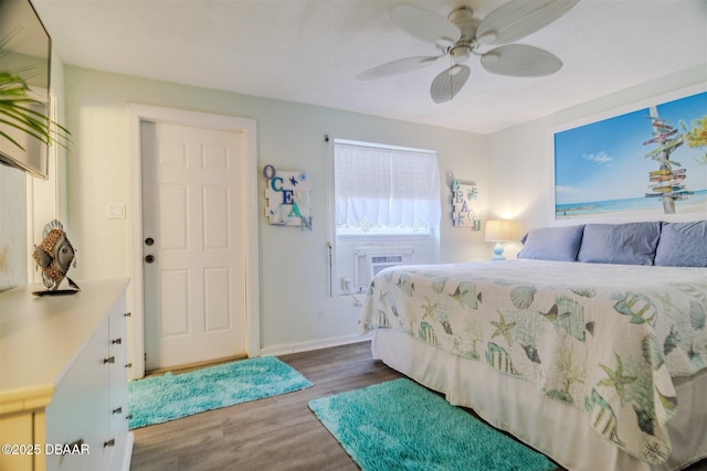 bedroom with cooling unit, dark hardwood / wood-style floors, and ceiling fan