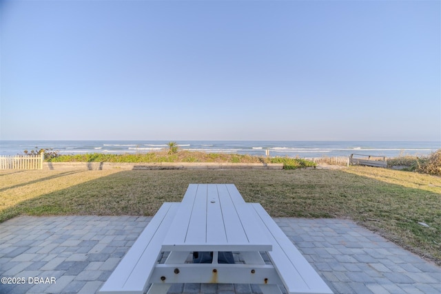 view of patio featuring a water view and a view of the beach