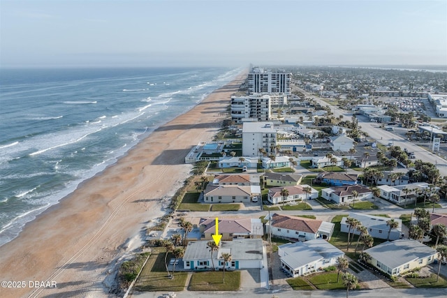 birds eye view of property with a beach view and a water view