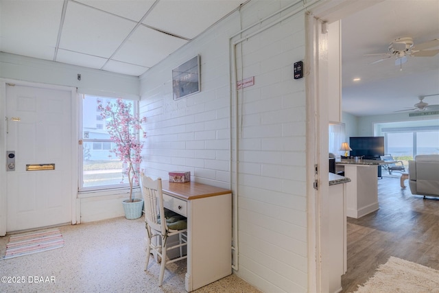 foyer entrance with a paneled ceiling and ceiling fan