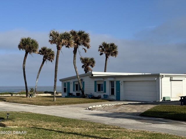 ranch-style house with a garage and a front yard