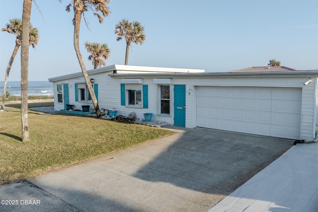 single story home with a garage, a front yard, and a water view