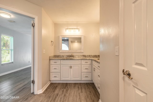3931 Tano Dr, Ormond Beach, FL 32174 - bathroom with wood finished floors, vanity, and baseboards