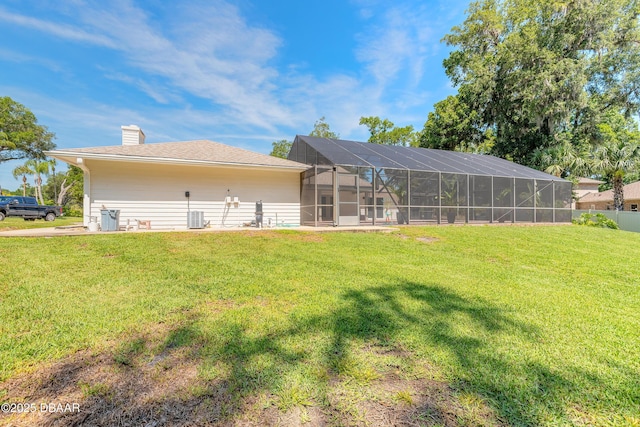 3931 Tano Dr, Ormond Beach, FL 32174 - rear view of house featuring a chimney, cooling unit, and glass enclosure