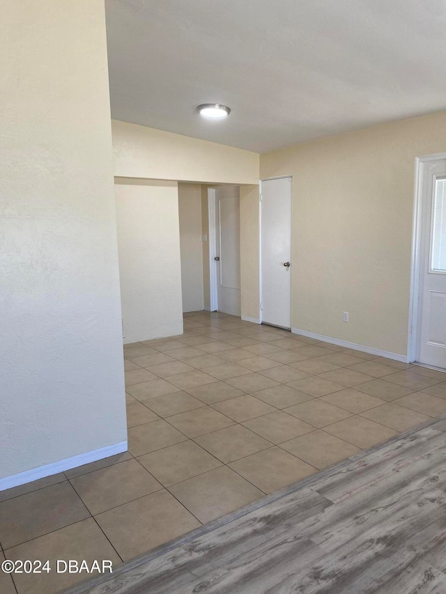 unfurnished room with light tile patterned floors