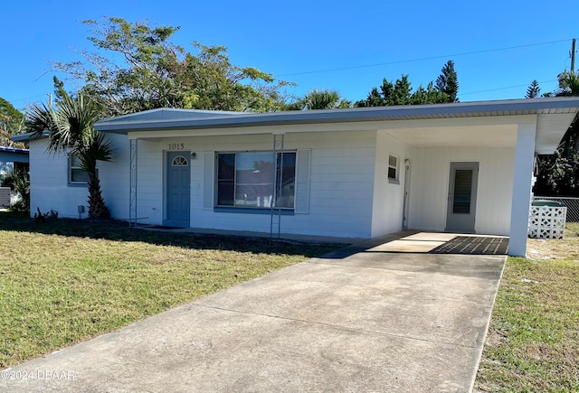 view of front facade with a front yard and a carport