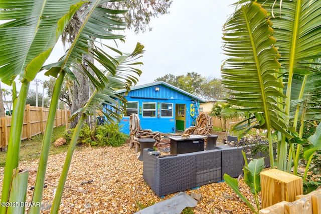 exterior space with an outdoor living space with a fire pit and an outdoor structure