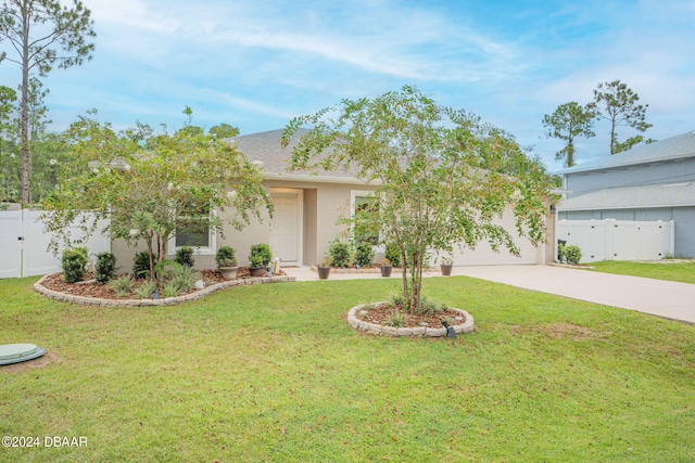 view of front of house with a garage and a front yard