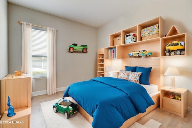 bedroom featuring multiple windows and light wood-type flooring