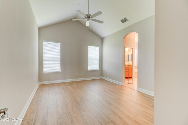 empty room featuring high vaulted ceiling, light hardwood / wood-style floors, and ceiling fan