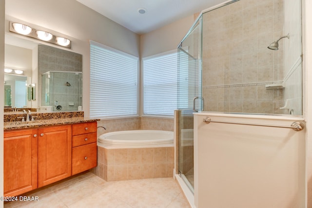 bathroom featuring vanity, tile patterned floors, and shower with separate bathtub