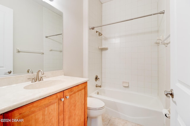 full bathroom featuring toilet, vanity, tiled shower / bath, and tile patterned flooring