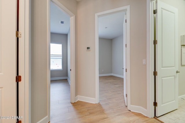 corridor with light wood-type flooring