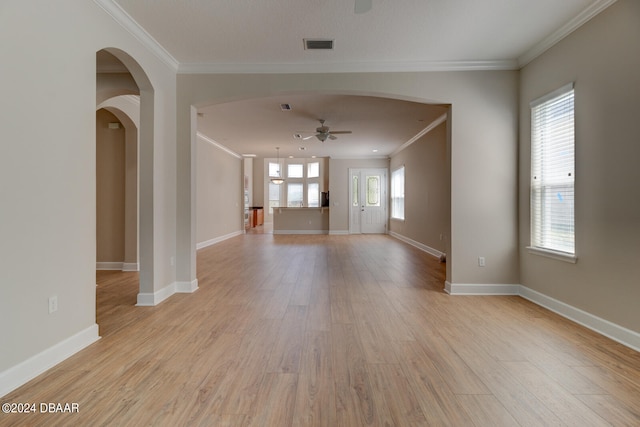 interior space featuring ceiling fan, light wood-type flooring, and ornamental molding