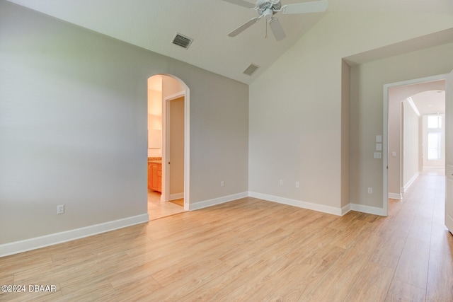 empty room with light hardwood / wood-style floors, ceiling fan, and vaulted ceiling